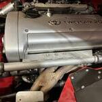 Before with coolant pipe over header